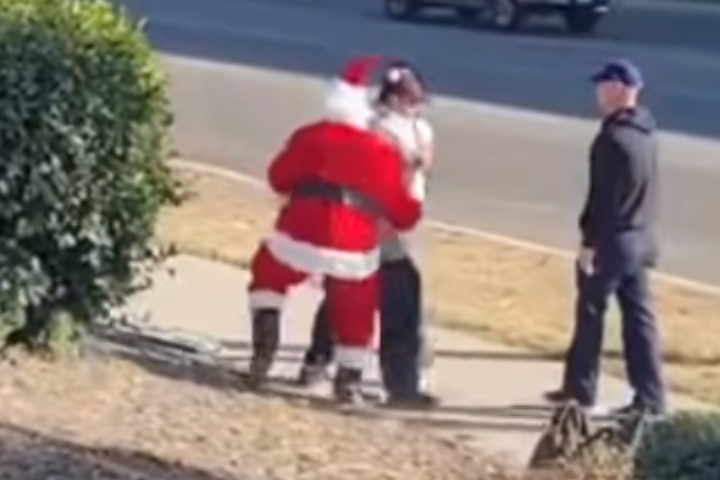 Three police officers, including one dressed as Santa, arrest a suspect in Riverside, Calif., on Dec. 10, 2020.