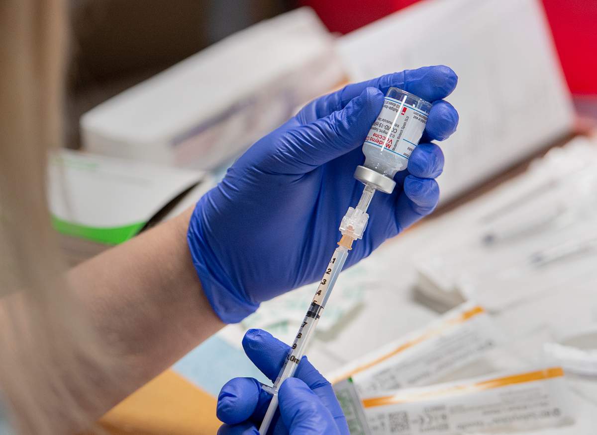 Amanda Parsons, a registered nurse on staff at the Northwood Care facility, prepares a dose of the Moderna vaccine in Halifax on Monday, Jan. 11, 2021. In a bid to control COVID-19, the federal government plans to make free vaccines available to everyone who lives in Canada over the course of 2021. THE CANADIAN PRESS/Andrew Vaughan-Pool.
