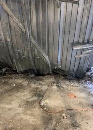 This is where Jacob Hurl was trapped. The small hole in middle is where his legs were stuck up to the top of his thigh, between the sheet metal (which is the floor that fell from above) and the concrete. 