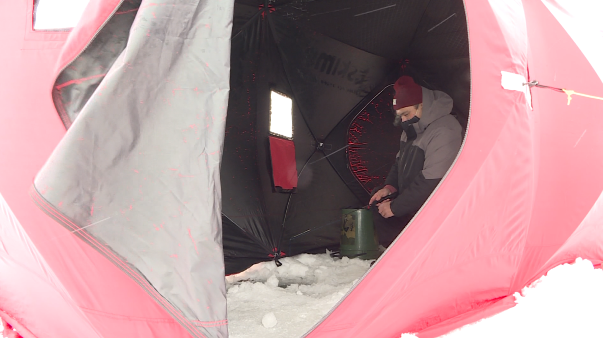 Leon Belandiuk fishing inside his tent at the FAAM derby on Sunday at Lake Winnipeg.