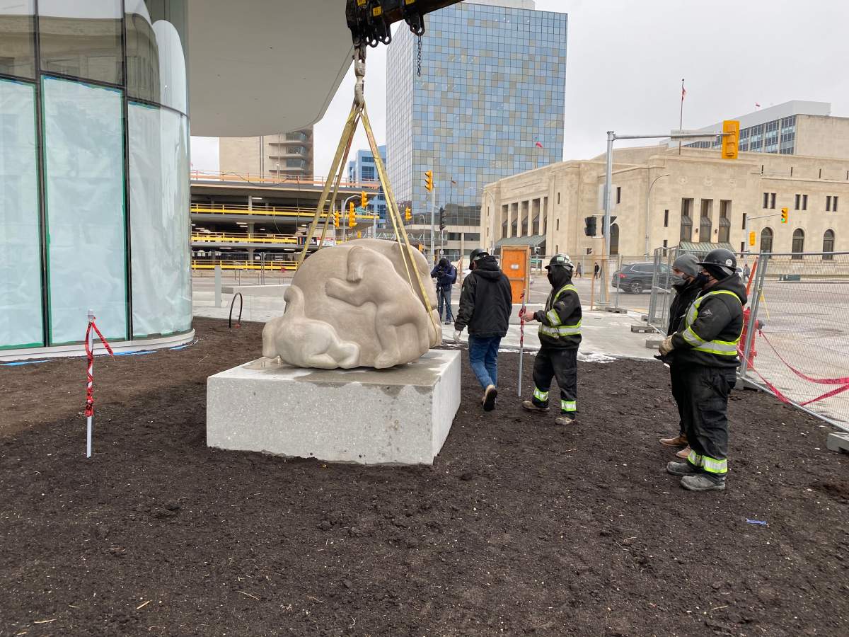 Workers install “Time to Play” by Abraham Anghik Ruben outside the WAG’s new Inuit Art Centre.
