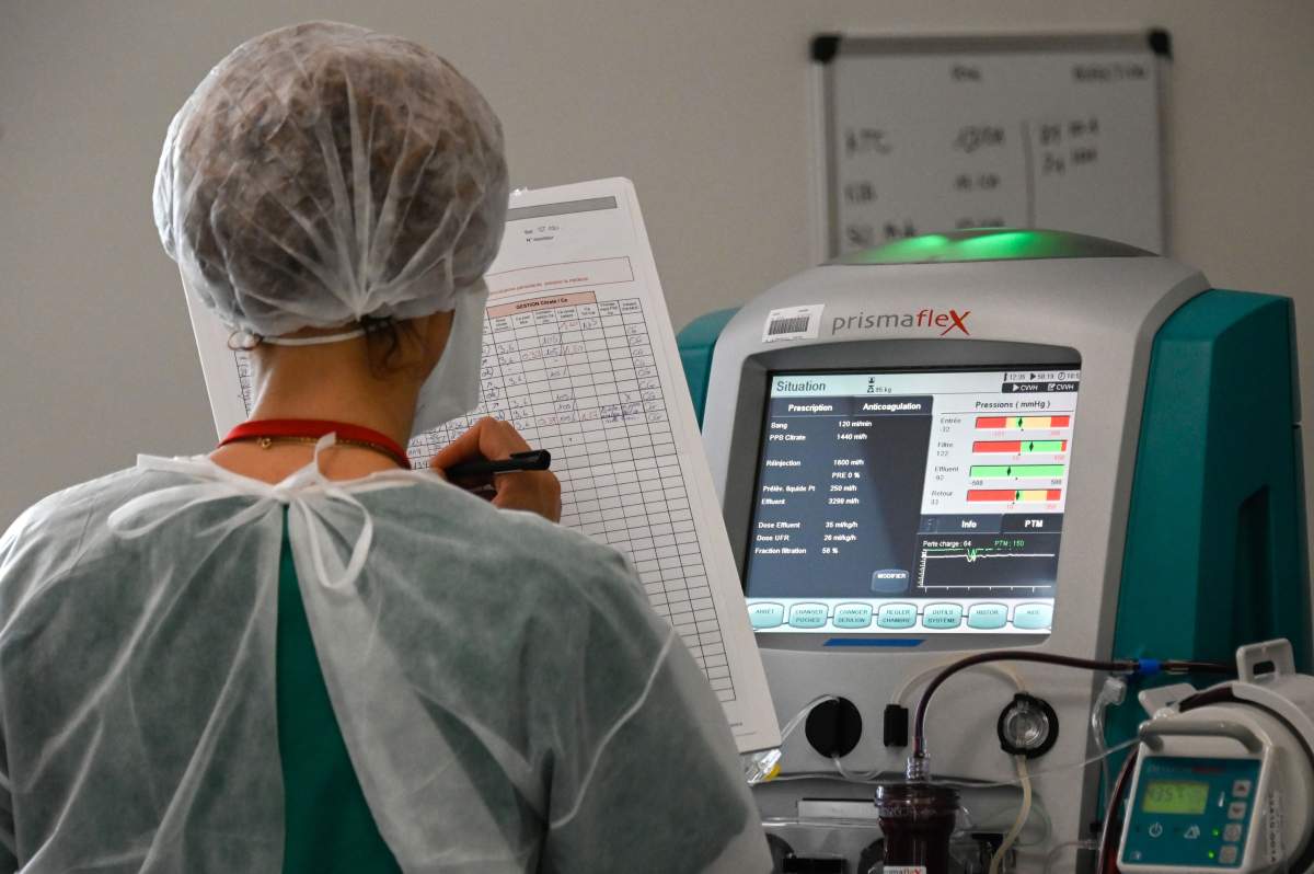 A nurse notes the medical data of a COVID-19 patient at the Pasteur hospital resuscitation unit in Colmar, eastern France, on Jan. 22, 2021.