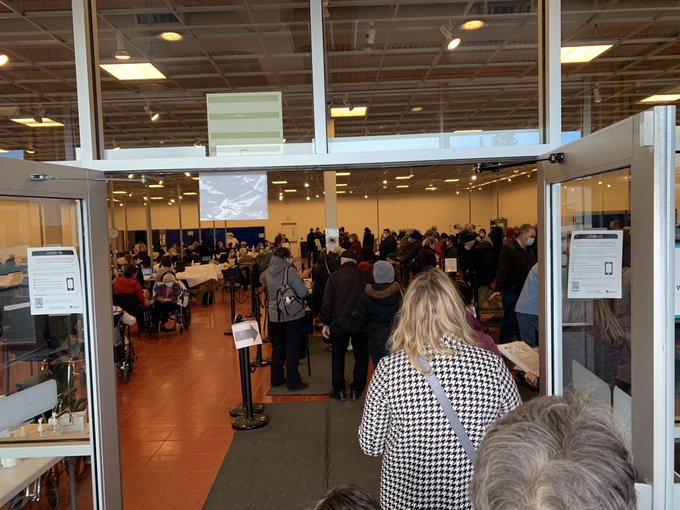 Long lines and crowds of people are seen inside a vaccination facility on Day 1 of Phase 1B of Alberta’s COVID-19 vaccine rollout on Feb. 25, 2021.