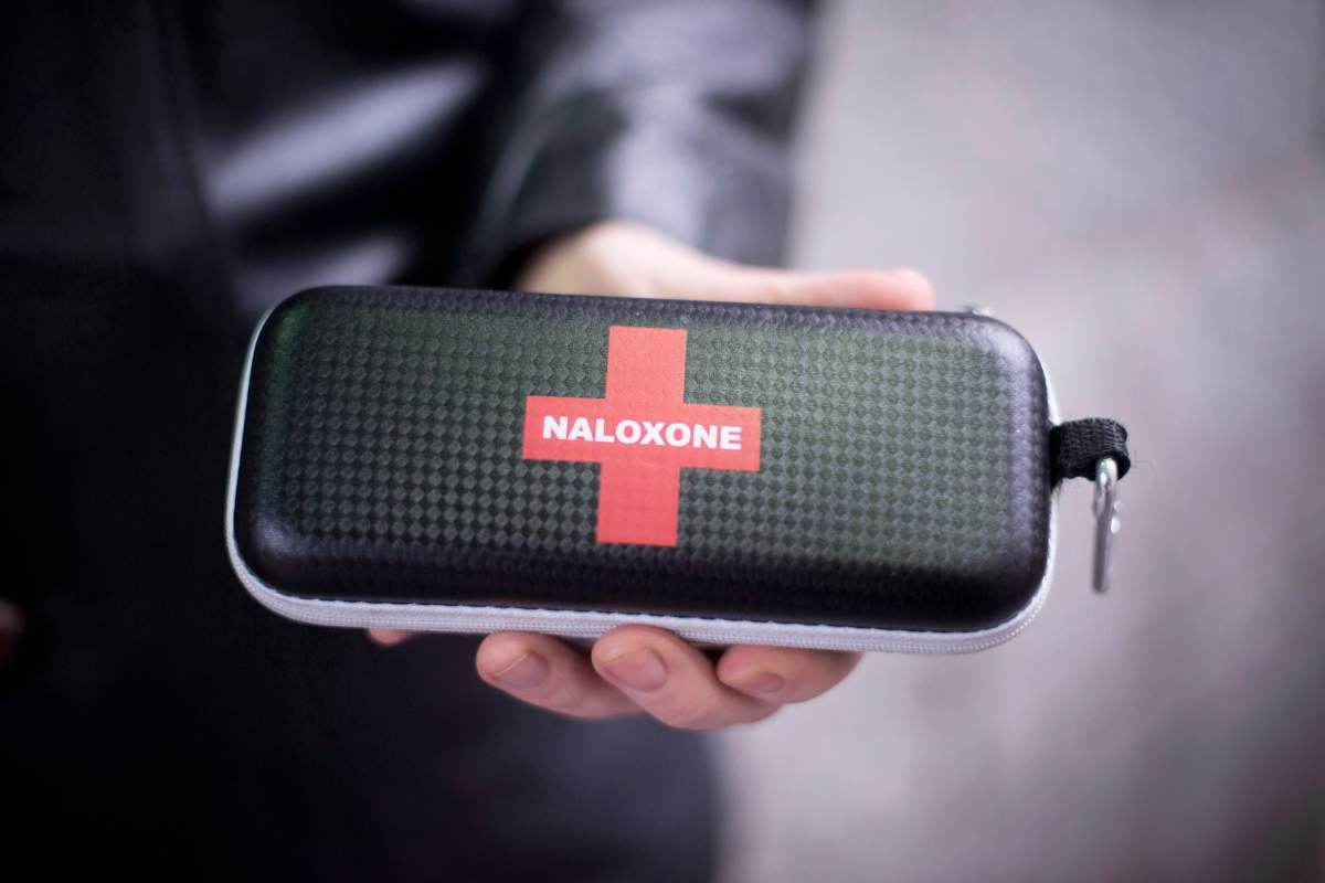A person holds a naloxone overdose prevention kit pictured at a pharmacy in Kingston, Ont., on Saturday, Jan. 23, 2021.