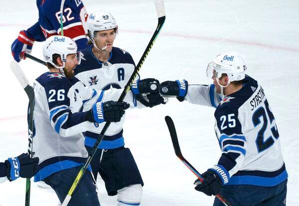 Winnipeg Jets’ Paul Stastny, right, celebrates his goal against the Montreal Canadiens with teammates Blake Wheeler, left, and Mark Scheifele. THE CANADIAN PRESS/Paul Chiasson