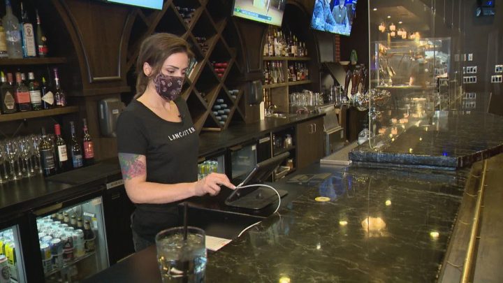 Tracy Lee Herauf types in a takeout order at The Lancaster Taphouse downtown location.