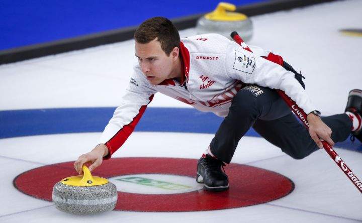 Team Canada skip Brendan Bottcher makes a shot against the United States at the Men's World Curling Championships in Calgary, Alta., Monday, April 5, 2021.