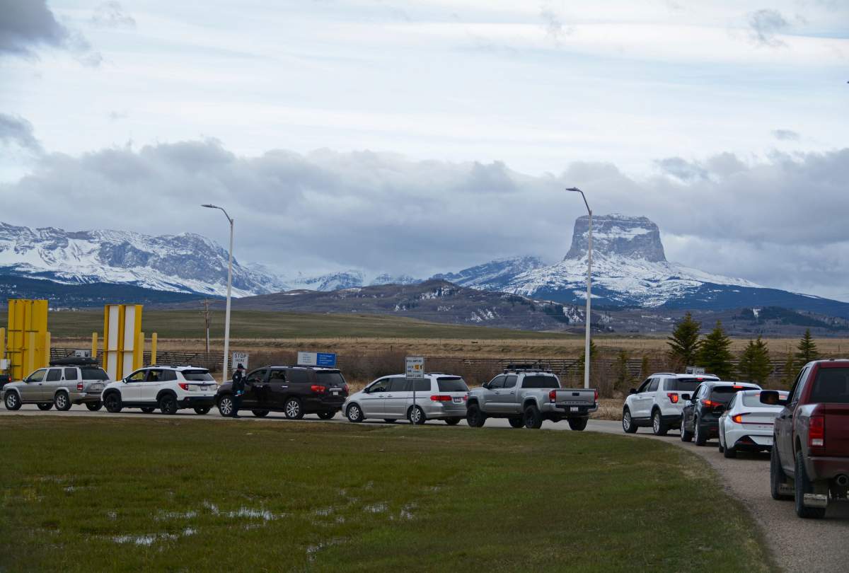 In this Thursday, April 29, 2021, photo, Canadians drive-in at the Piegan-Carway border to receive a COVID-19 from the Blackfeet tribe near Babb, Mont.