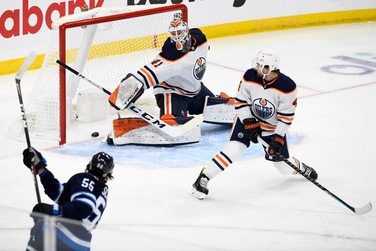 Winnipeg Jets’ Mark Scheifele (55) scores on Edmonton Oilers goaltender Mike Smith (41) during first period NHL Stanley Cup playoff action in Winnipeg on Monday, May 24, 2021.