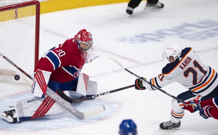 Edmonton Oilers’ Dominik Kahun (21) scores the winning goal on Montreal Canadiens goaltender Cayden Primeau (30) during overtime NHL hockey action Wednesday, May 12, 2021 in Montreal.