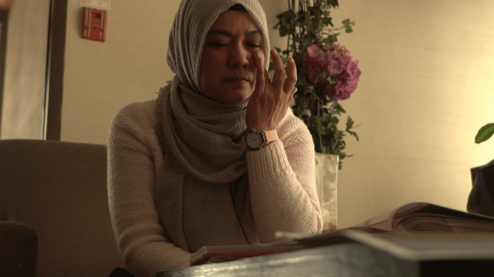 Kamila Telendibaeva breaks down while looking at photos of her husband, Huseyin Celil. The Chinese-Canadian has been detained in China since 2006.
