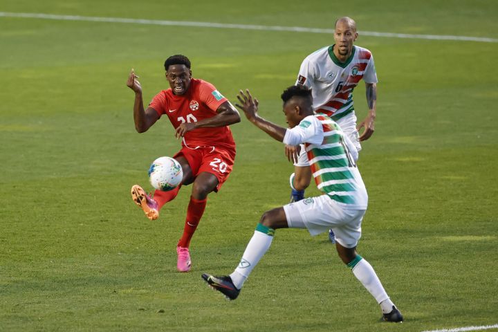 Canada’s Jonathan David (20) tries to score past Suriname’s Kelvin Leerdam (18) during the first half of a World Cup 2022 Group B qualifying soccer match Tuesday, June 8, 2021, in Bridgeview, Ill.