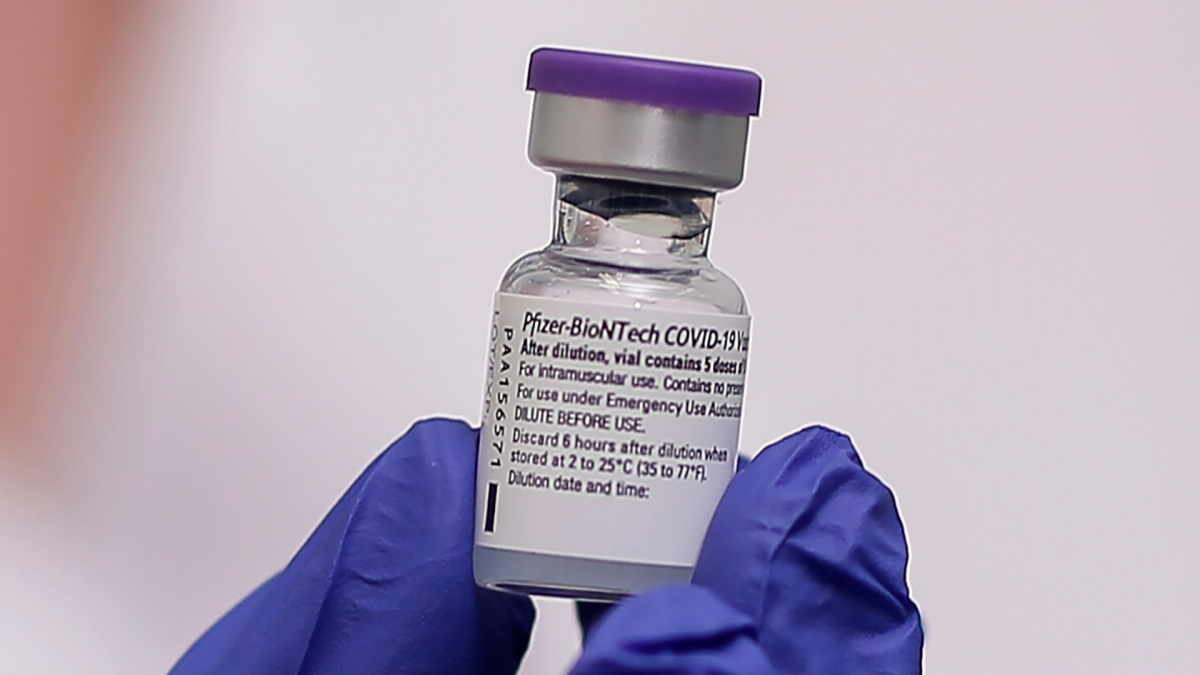 A nurse holds a dose of the Pfizer-BioNTech vaccine against the COVID-19, in Athens, Sunday, Dec. 27, 2020.
