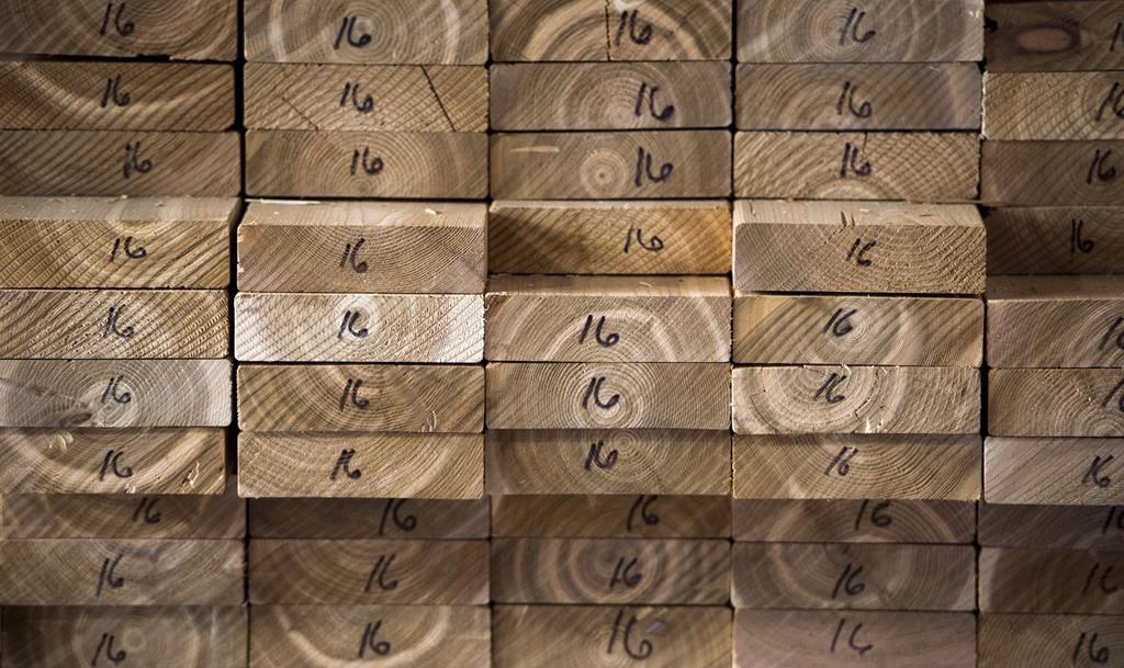 Cedar planks are stacked at a lumber yard, Tuesday, April 25, 2017 in Montreal. Canfor Corp. says it is curtailing production capacity at its Canadian sawmills beginning Monday as a result of extreme wildfire conditions in Western Canada. THE CANADIAN PRESS/Paul Chiasson.