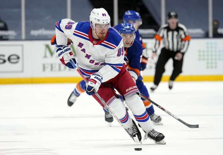 FILE – In this April 11, 2021, file photo, New York Rangers’ Pavel Buchnevich (89) skates with the puck during the third period of an NHL hockey game against the New York Islanders in Uniondale, N.Y. The Rangers continued their offseason makeover Friday, July 23, 2021, by trading fourth-leading scorer Buchnevich to the St. Louis Blues for forward Sammy Blais and a 2022 second-round pick.