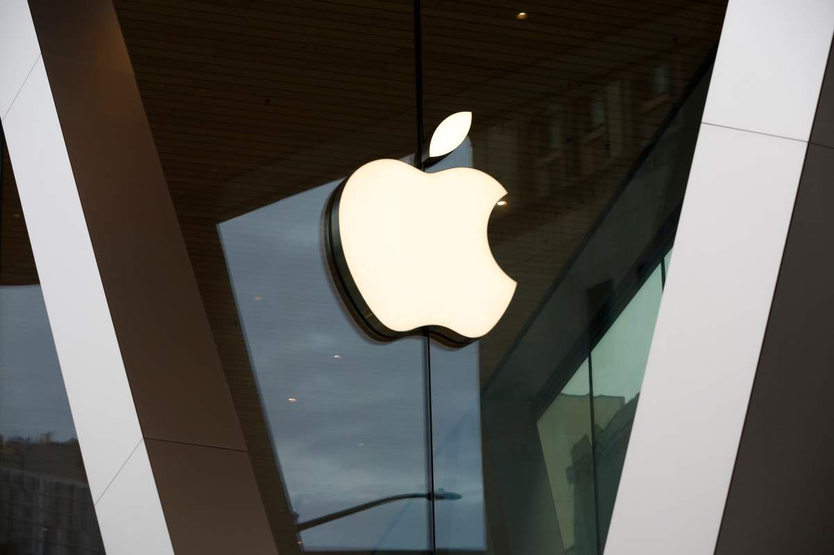 FILE - In this Saturday, March 14, 2020 file photo, an Apple logo adorns the facade of the downtown Brooklyn Apple store in New York.