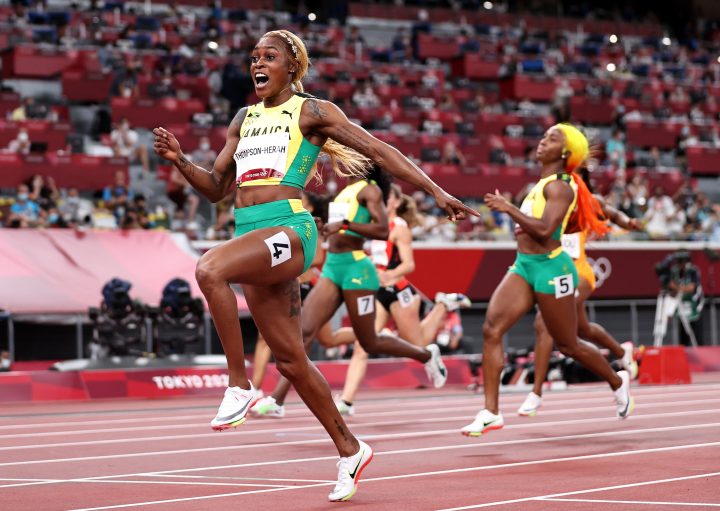 TOKYO, JAPAN - JULY 31: Elaine Thompson-Herah of Team Jamaica celebrates as she crosses the finish line to win the gold medal in the Women's 100m Final on day eight of the Tokyo 2020 Olympic Games at Olympic Stadium on July 31, 2021 in Tokyo, Japan. 