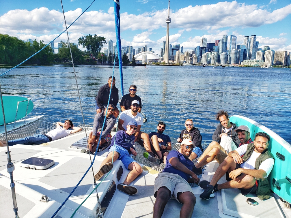 Lazer Technologies employees pose with Toronto's CN Tower in the background