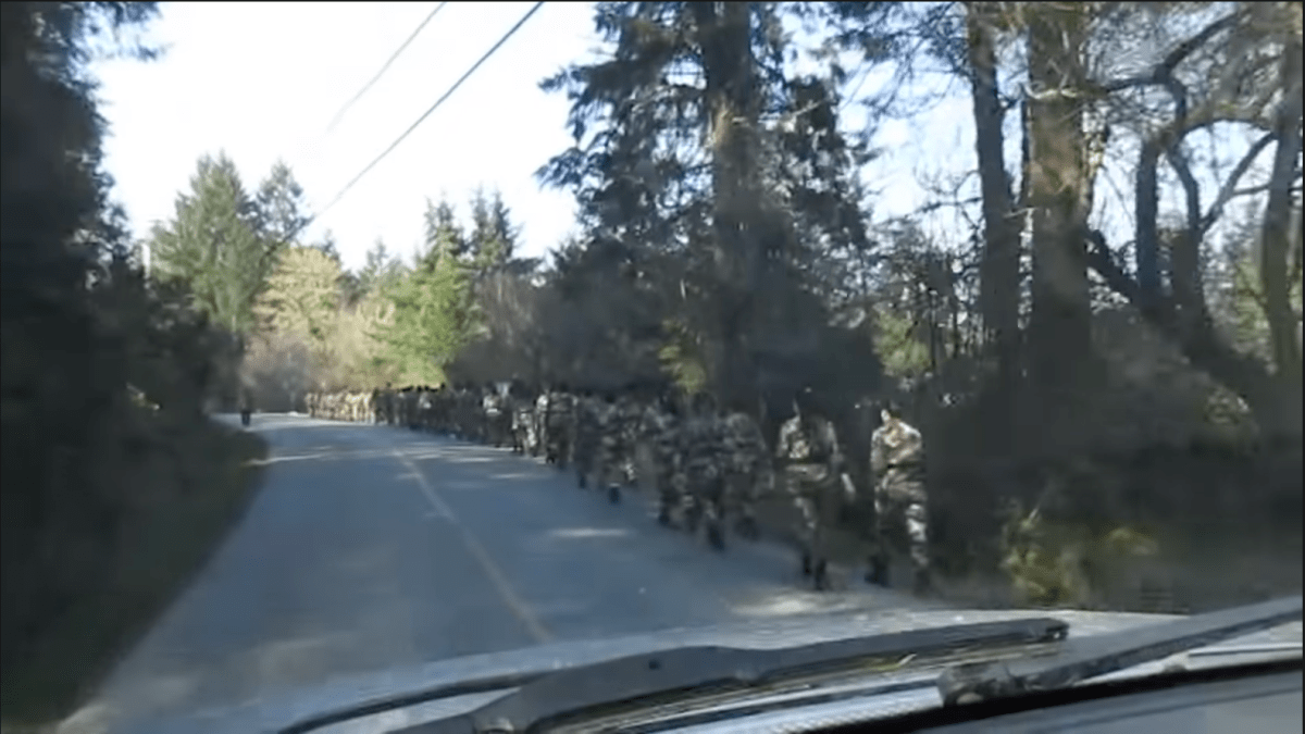 A screenshot from a video recorded by Salt Spring Island resident Joe Clemente in March 2018, which appears to show around 50 East Asian-looking men and women marching in military uniforms.