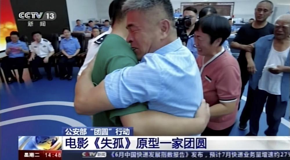 In this image taken from a video footage run by China's CCTV via AP Video, Guo Gangtang at right embraces his long lost son Guo Xinzhen during a reunion after 24 years in Liaocheng in Central China's Shandong province on Sunday, July 11, 2021. Guo was abducted as a toddler outside their home.