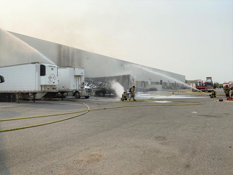 Calgary firefighters battle a blaze at a trailer parked at the loading dock of Stericycle in Southeast Calgary on Wednesday, July 28, 2021.