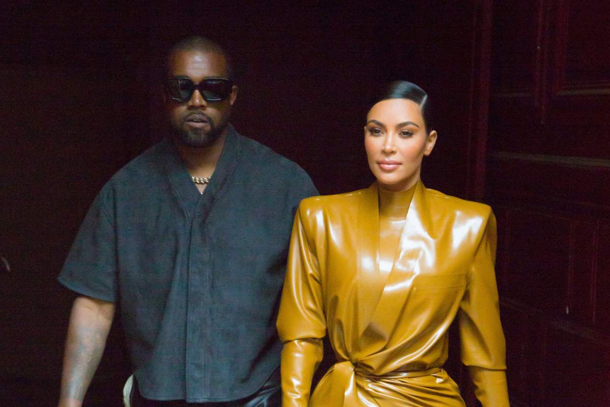 Kanye West and Kim Kardashian walking together.