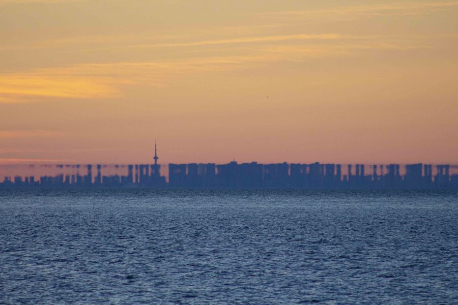 toronto skyline from across lake ontario distorted by mirage