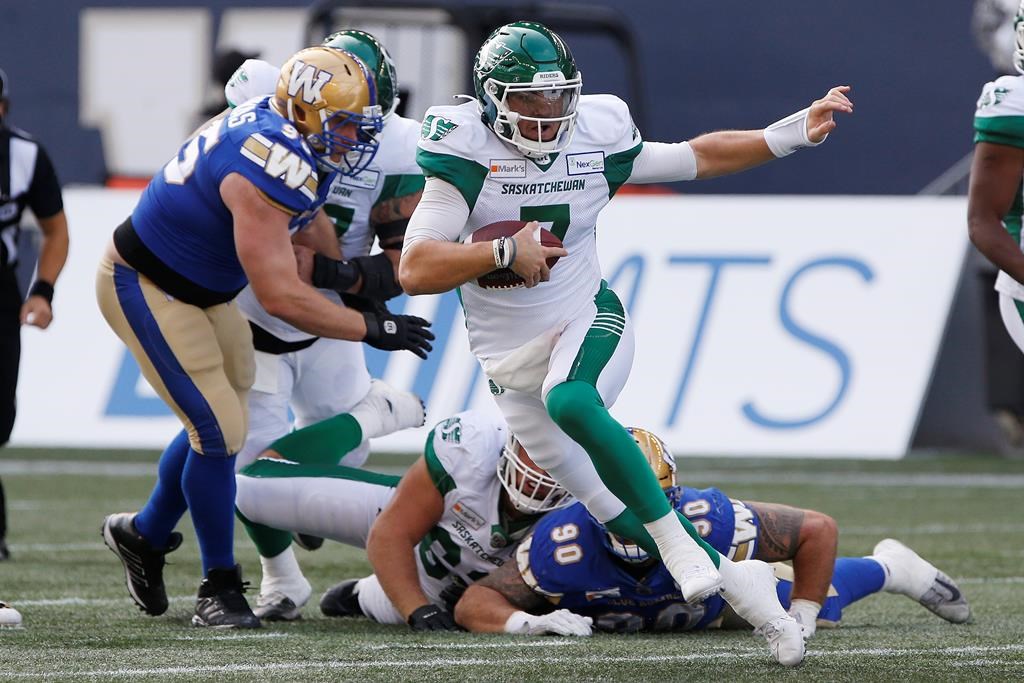 Saskatchewan Roughriders quarterback Cody Fajardo (7) scrambles for the first down during the first half of CFL action against the Winnipeg Blue Bombers in Winnipeg, Sept. 11, 2021.