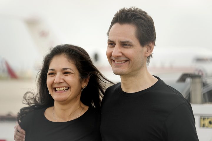 Michael Kovrig embraces his wife Vina Nadjibulla, left, after arriving at Pearson International Airport in Toronto, Saturday, Sept. 25, 2021.