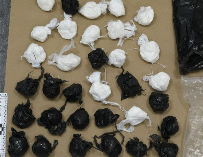 After the suspicious man was seen stashing the packages, a homeowner contacted police, who were able to determine that the bags contained a large amount of suspected cocaine.
