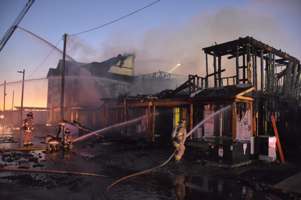 Ottawa fire crews douse flames at a Stittsville housing development on Wednesday, Oct. 6, 2021.