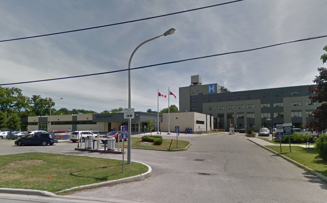 An outdoor, sunny photo of a hospital.
