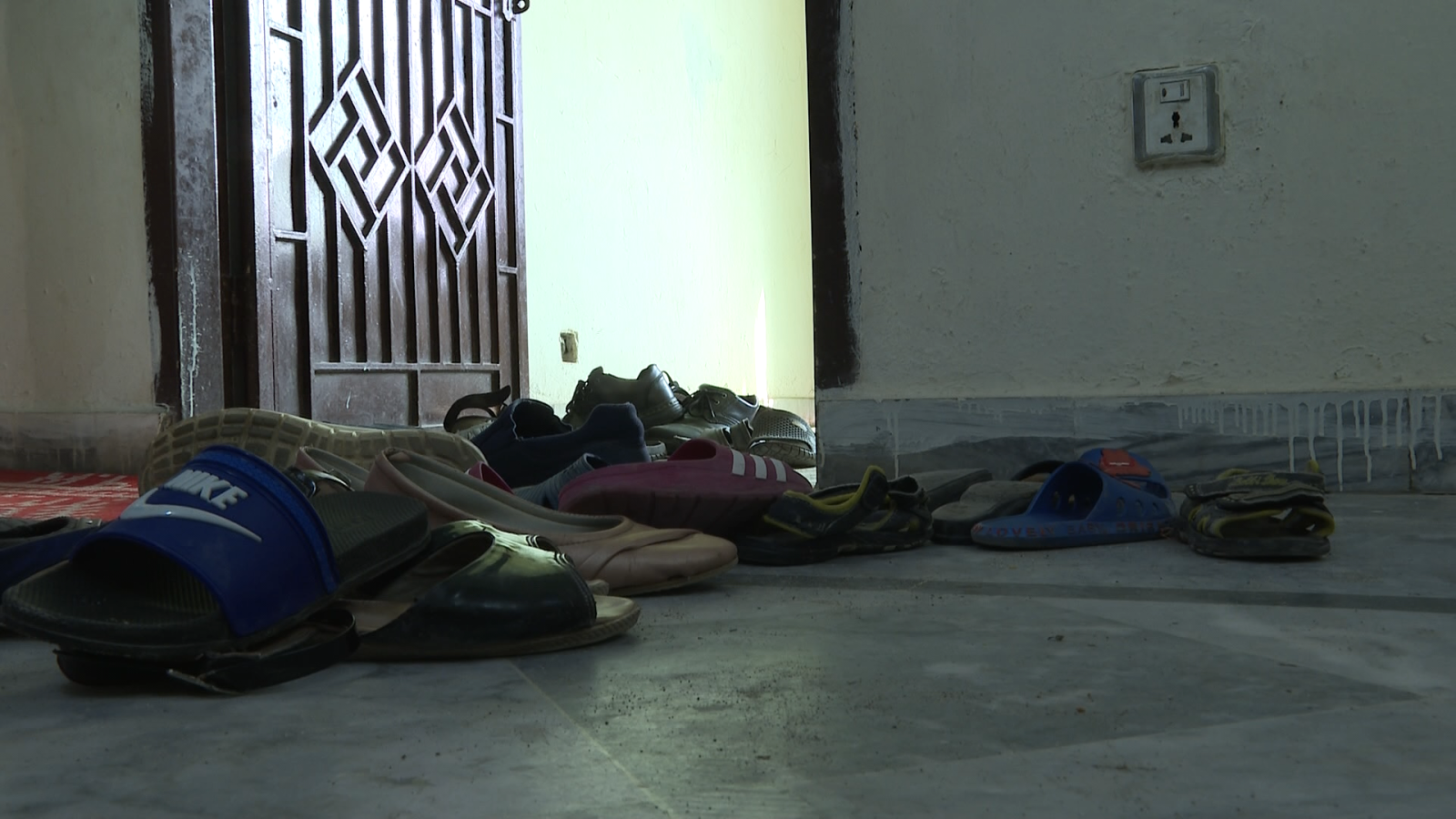 Shoes at the entrance to an Islamabad apartment where Hazara refugees wait to be resettled.