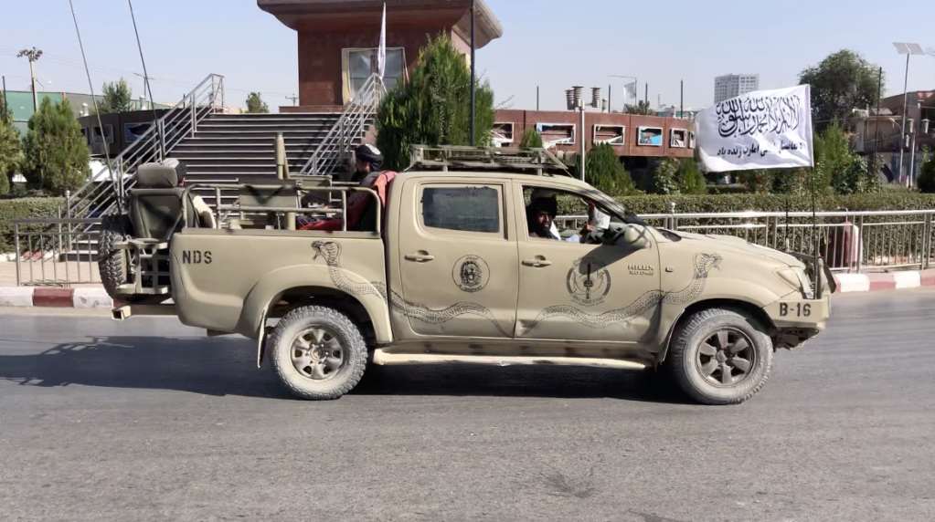 Gunmen in truck flying Taliban flag in Kabul.
