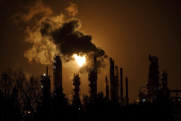 A flare stack lights the sky from the Imperial Oil refinery in Edmonton on Friday, Dec. 28, 2018.