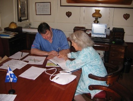 Signing a copy of The Charley-Man for Captain Jean-Alain Moradec of the French barque Belem, in port for Quebec’s 400th anniversary in 2008.