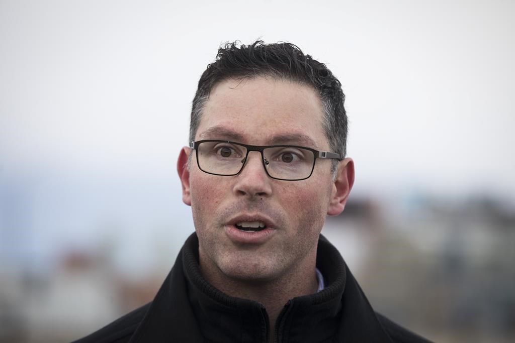 Alberta cabinet minister Doug Schweitzer makes a statement at a news conference. In a tweet on Friday afternoon, Schweitzer announced he has provided Premier Jason Kenney with his resignation from Cabinet.  THE CANADIAN PRESS/Todd Korol.