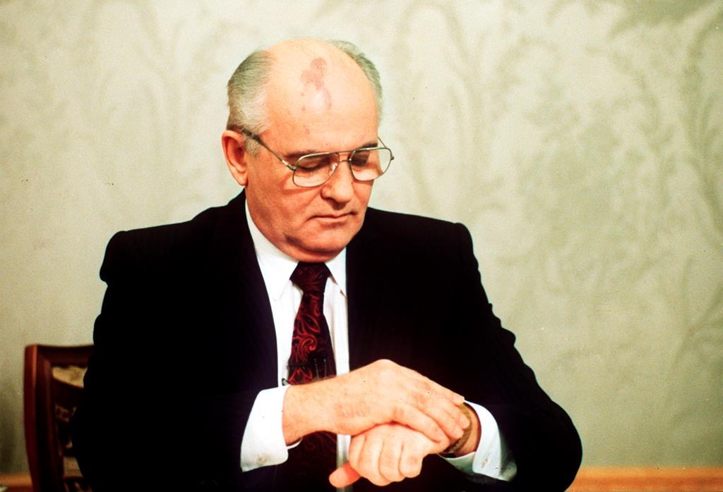 Soviet President Mikhail Gorbachev checks the time on his watch before his resignation speech in the Kremlin on Wednesday, Dec. 25, 1991, drawing a line under more than 74 years of Soviet history.