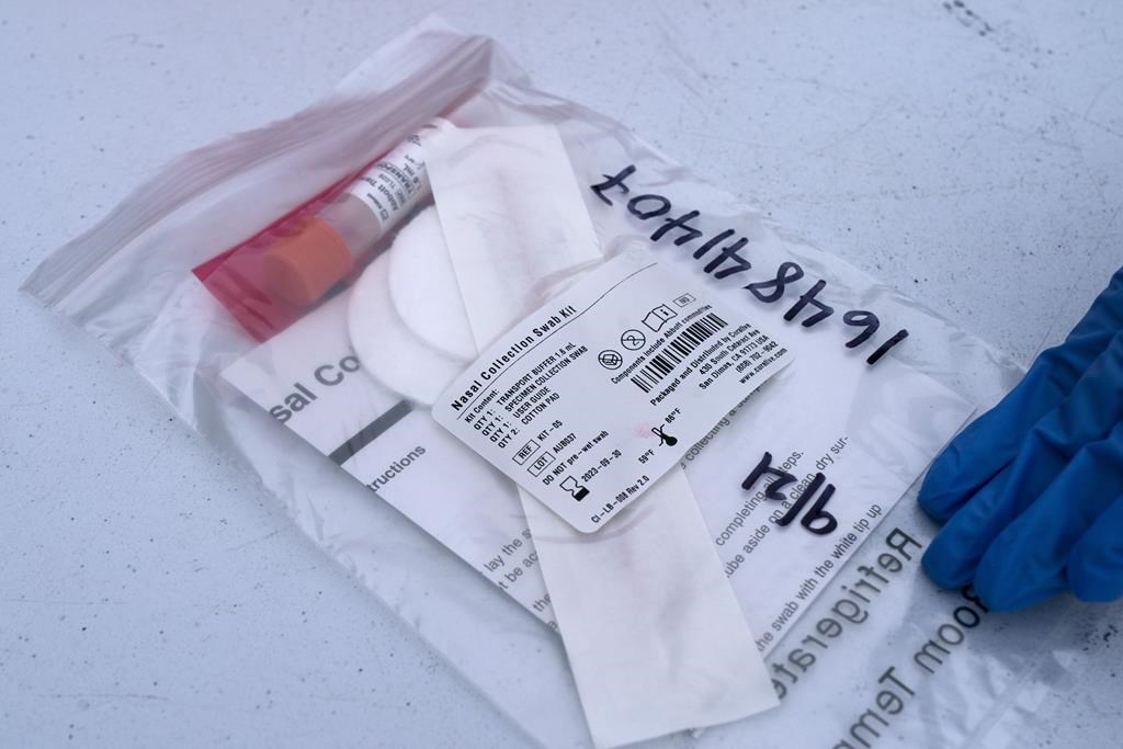 A PCR test is prepared to test for COVID-19, Tuesday, Dec. 21, 2021.