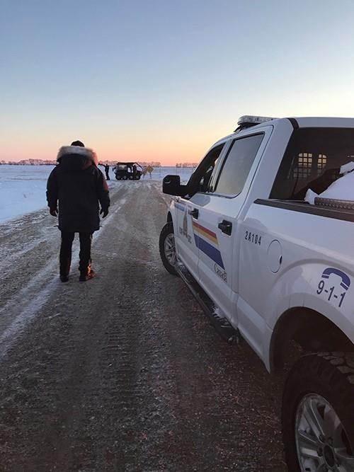 RCMP officers are shown near the town of Emerson, Man., on Wednesday Jan. 19, 2022. Mounties in Manitoba say they have found the bodies of four people including an infant and a teen, near the United States border. THE CANADIAN PRESS/HO-RCMP