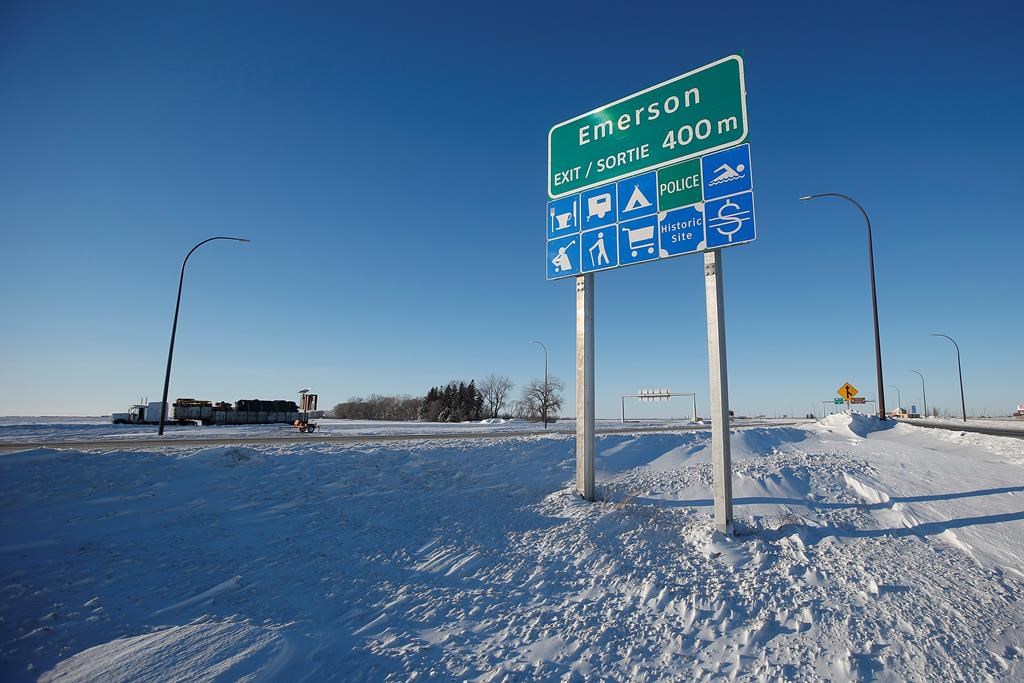 Road signage is photographed just outside of Emerson, Man. on Thursday, January 20, 2022. American investigators believe the deaths of four people, including a baby and a teen, whose bodies were found in Manitoba near the United States border are linked to a larger human smuggling operation. THE CANADIAN PRESS/John Woods