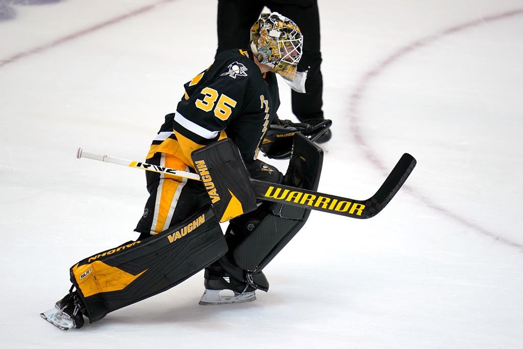 Pittsburgh Penguins goaltender Tristan Jarry begins to celebrate after blocking a shot by Winnipeg Jets' Pierre-Luc Dubois during an NHL hockey game shootout in Pittsburgh, Sunday, Jan. 23, 2022.