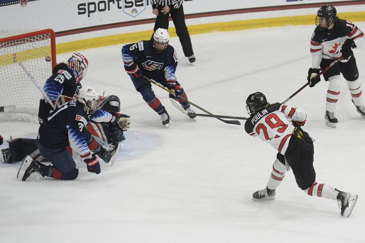 Canada’s Marie-Philip Poulin (29) shoots the game winning goal during the overtime period of a women’s exhibition hockey game ahead of the Beijing Olympics, Friday, Dec. 17, 2021, in Maryland Heights, Mo.