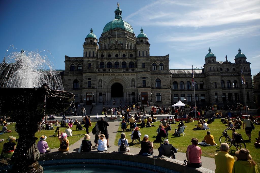 People honour Chantel Moore during a healing gathering at the B.C. Legislature in Victoria on Thursday, June 18, 2020. A coroner’s inquest into the police shooting of the 26-year-old Indigenous woman has been delayed until May. THE CANADIAN PRESS/Chad Hipolito