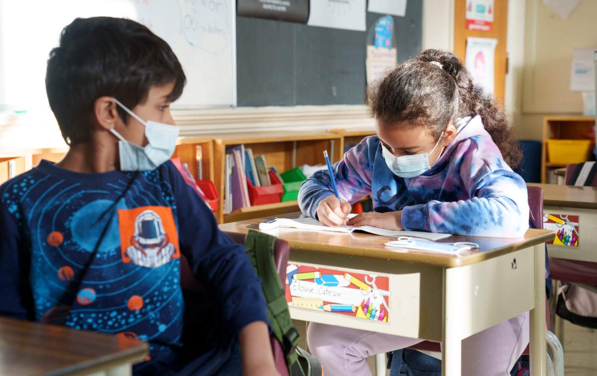 Students in an elementary class get back to work as Quebec students get back to school in Montreal on Tuesday, Jan. 18, 2022.