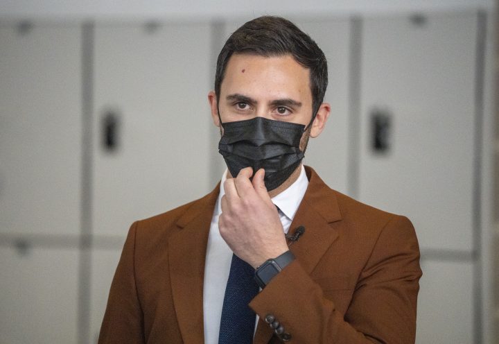 Ontario Education Minister Stephen Lecce adjusts his mask as he tours a COVID-19 vaccination site in Markham, Ontario on Monday January 24, 2022.
