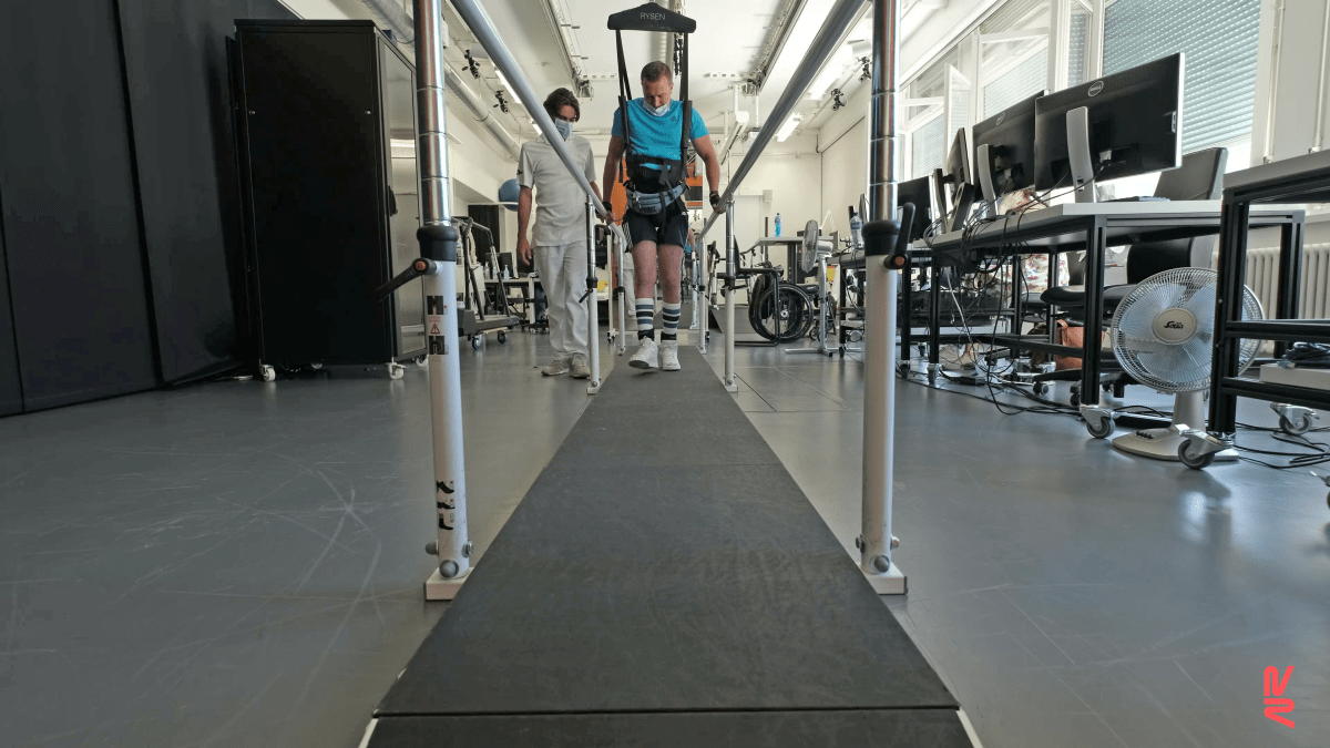 A patient with a complete spinal cord injury walks with the help of the device after five months of rehab.