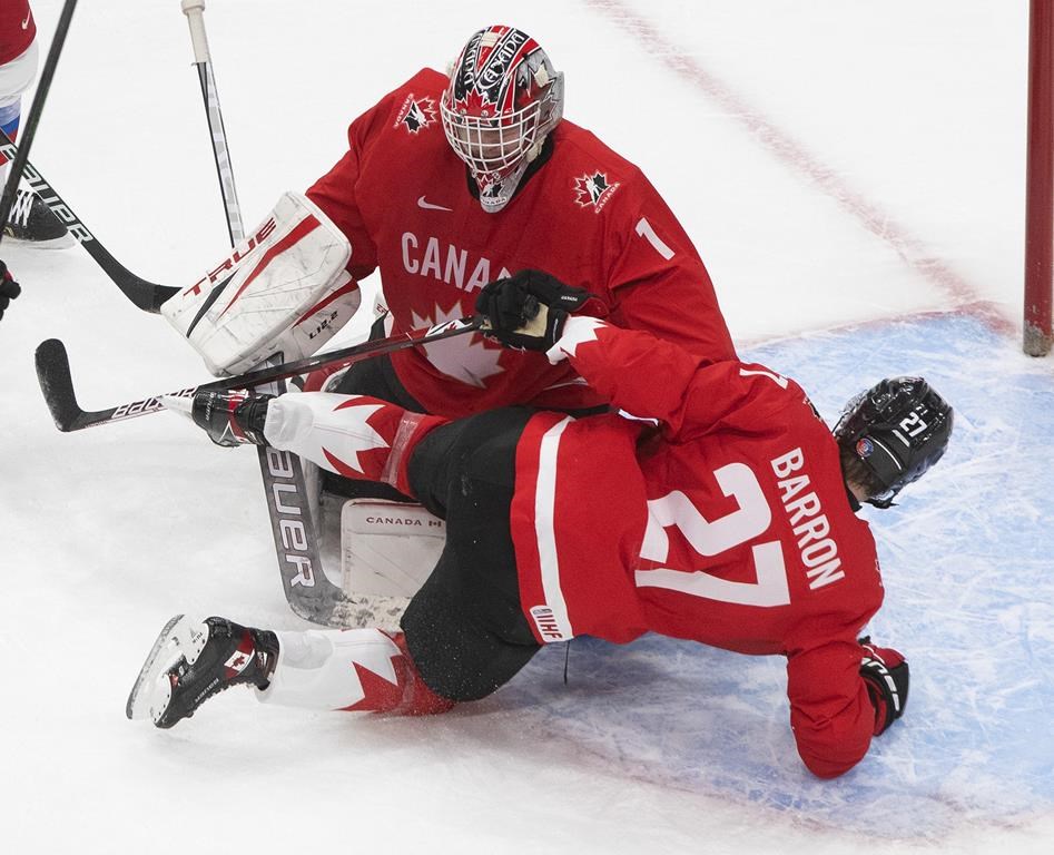 Canada's Justin Barron (27) crashes into his goalie Devon Levi (1) against Russia during second period IIHF World Junior Hockey Championship action in Edmonton on Monday, January 4, 2021. 