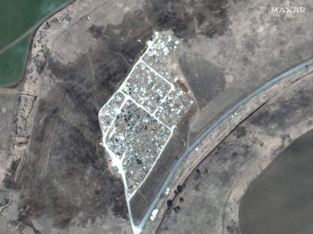 The view of a cemetery near Vynohradne, Ukraine, approximately 12 kilometers east of Mariupol, on March 29, 2022. Fresh trenches have appeared on the northeastern tip of the cemetery.