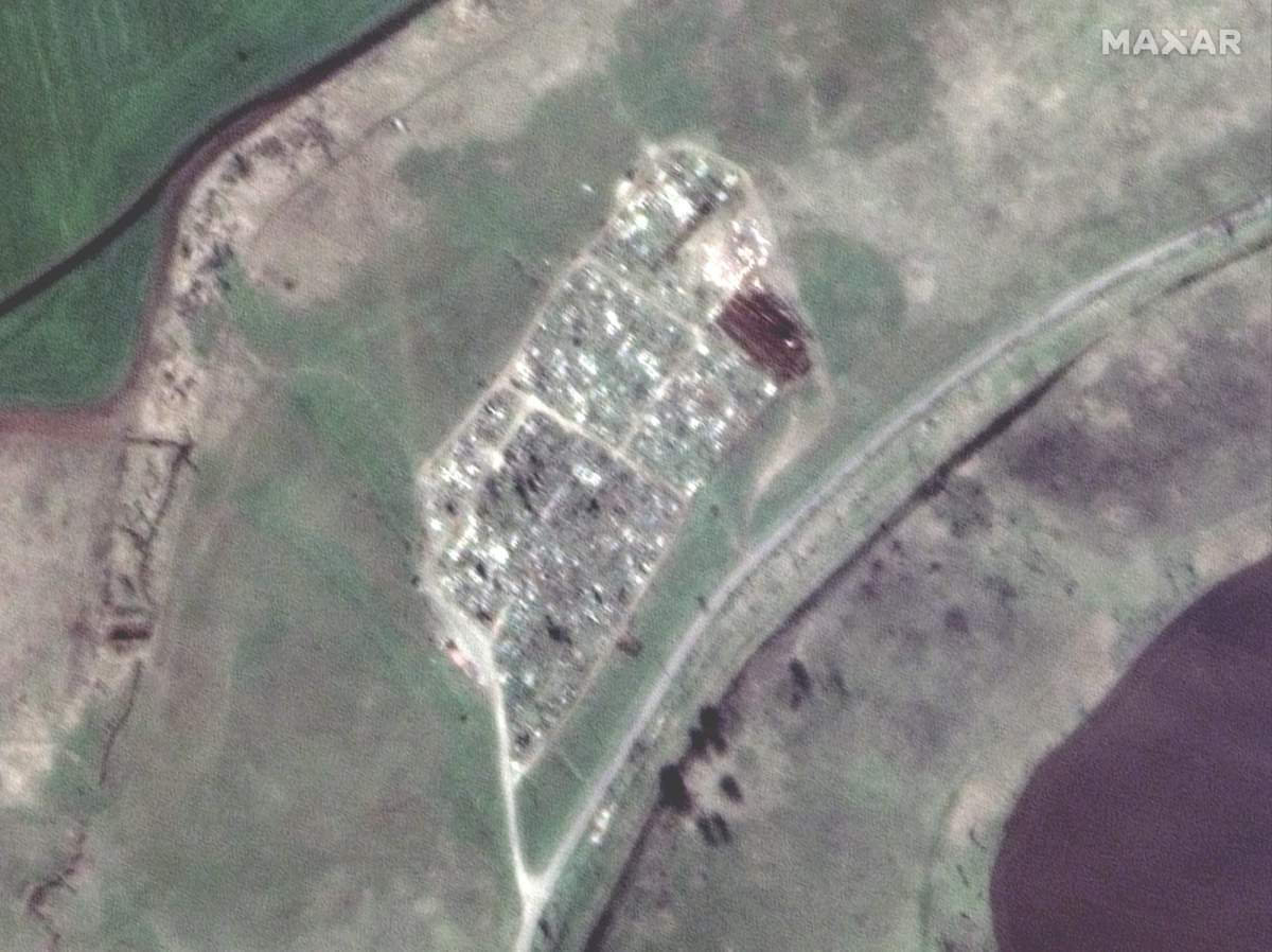 The view of a cemetery near Vynohradne, Ukraine, approximately 12 kilometers east of Mariupol, on March 29, 2022. The trenches on the northeastern tip of the cemetery have more than doubled in size since late March.